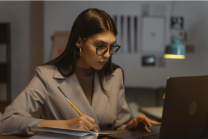 Woman in Gray Blazer Using Laptop Computer
